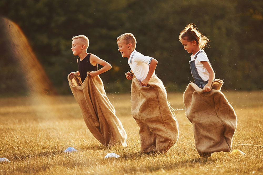 kids playing a game of potato sack