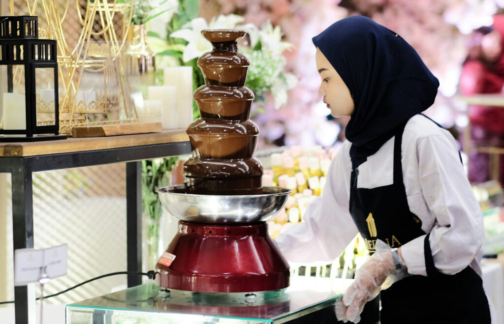 caterer setting up a chocolate fountain